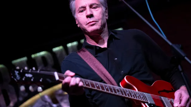 Blinken rocks out with Ukrainian band in underground venue, performing ‘Rockin’ in the Free World’ on guitar.